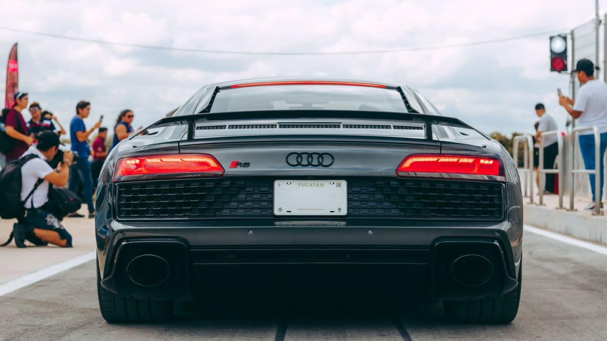 Rear view of a gray Audi R8 at a car event.