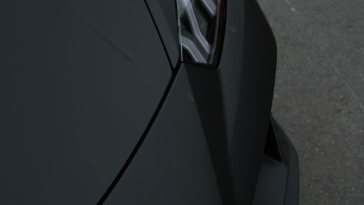 Photo: Hugo Alonso / Pexels Close view of the front corner and headlight of a black Lamborghini Aventador.