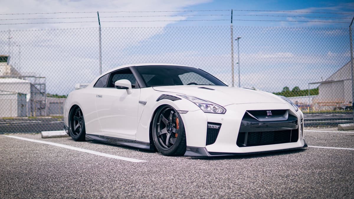 Photo: FBO Media / Pexels Customized white Nissan GT-R R35 parked in an outdoor lot.