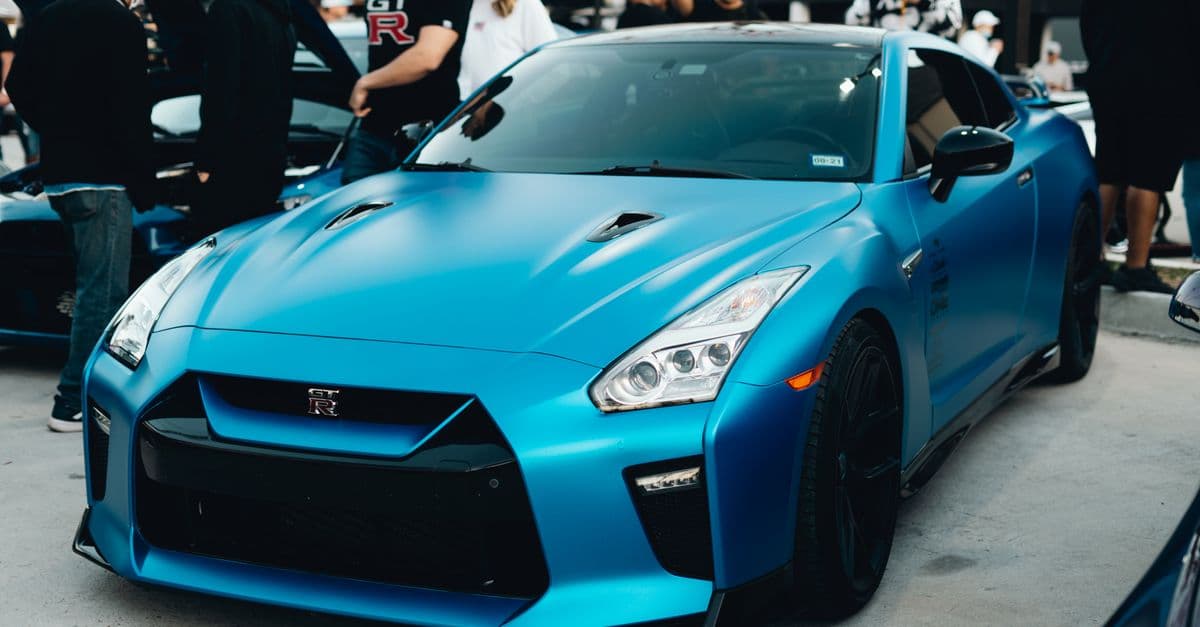 Photo: Adrian Newell / Pexels Blue Nissan GT-R R35 at an outdoor car show.